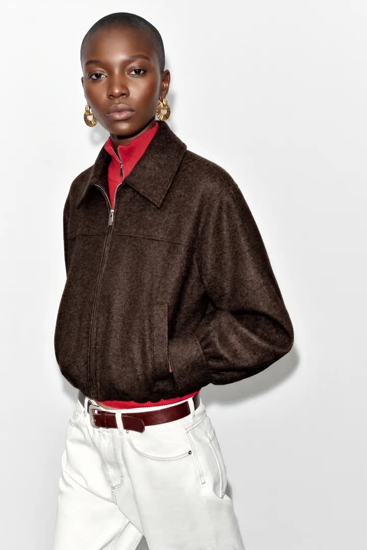 Model wearing the brown coat in a studio